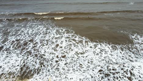 beach at vasi rajodi beach surfing on waves timelaps india mumbai maharashtra water sport drone shot birds eye view