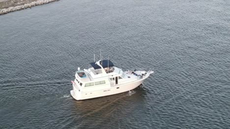 Aerial-View-Of-White-Motor-Yacht-Cruising-In-The-Lake