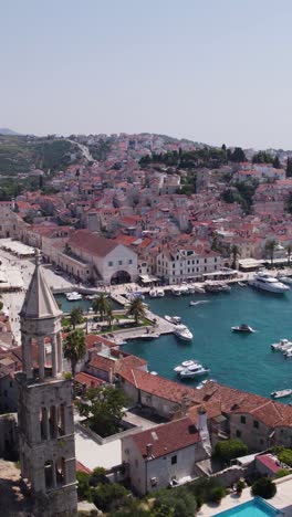 Picturesque cityscape of Hvar town with harbor and waterfront, aerial view, Hvar Island, Croatia. vertical video