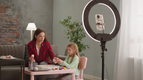 girl conducts lesson of easter eggs coloring and ebru art