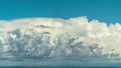 layers of clouds moving in sky above south pacific ocean, timelapse