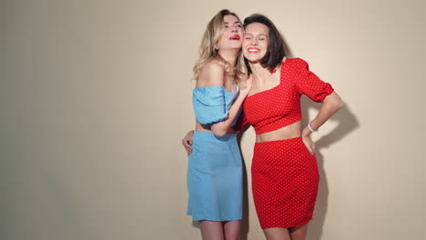 two women in stylish dresses