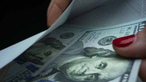 closeup businesswoman hands taking one hundred dollar bills from envelope