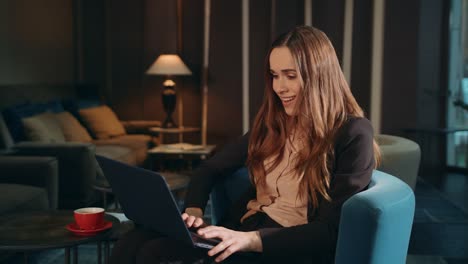 happy business woman working laptop computer in office lounge