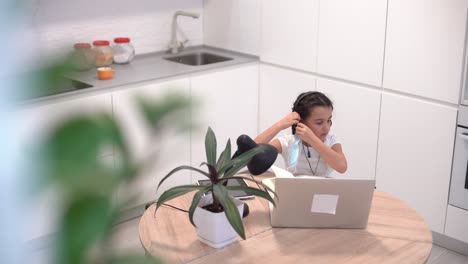 little-schoolgirl-takes-off-her-mask-and-headphones-after-taking-online-lessons