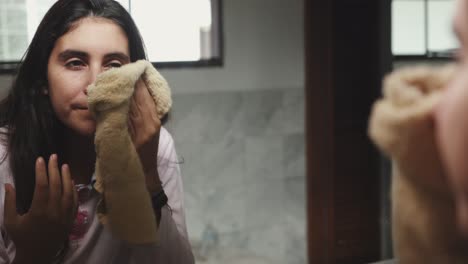 young-woman-drying-up-her-face-with-a-towel