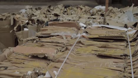 cardboard waste in bales overhead wide crane shot