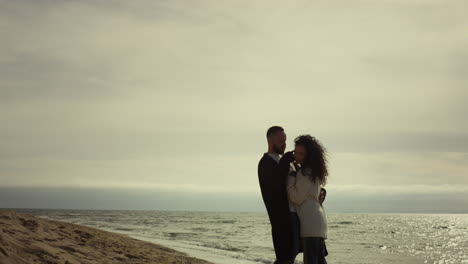 Couple-holding-each-other-at-sea.-Loving-people-hugging-together-at-ocean-coast.