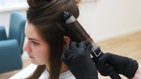 woman getting her hair curled at a salon