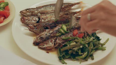 pov shot of enjoying a traditional pinoy local daily meal of fried galonggong and kangkong showing the authentic philippine cuisine