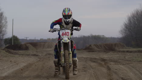 motocross rider starting up bike