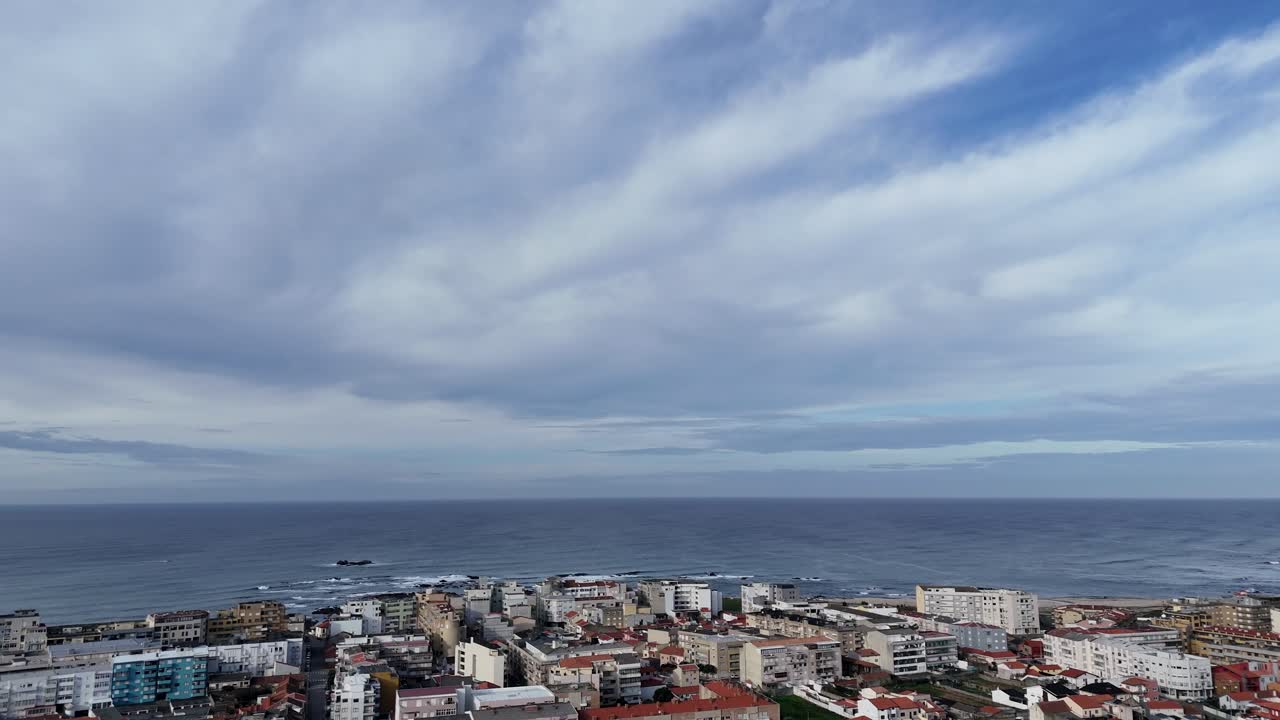 Aerial - Póvoa de Varzim beach zone with ocean view and city buildings in Portugal