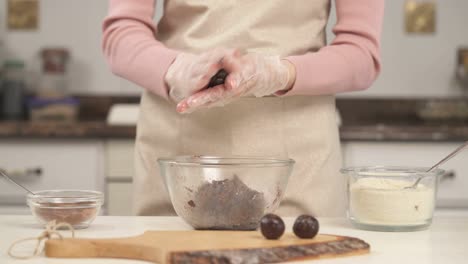 a skillful housewife making sweet tasty chocolate candies. healthy nutrition concept. homemade sweets