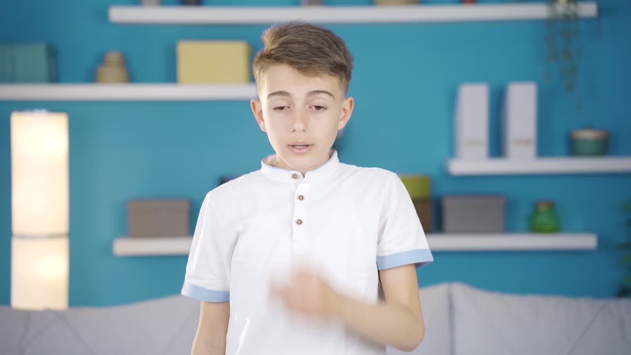 Boy yawning sleepily looking at camera.