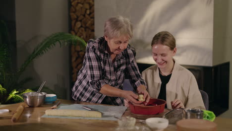 grandmother and granddaughter baking together