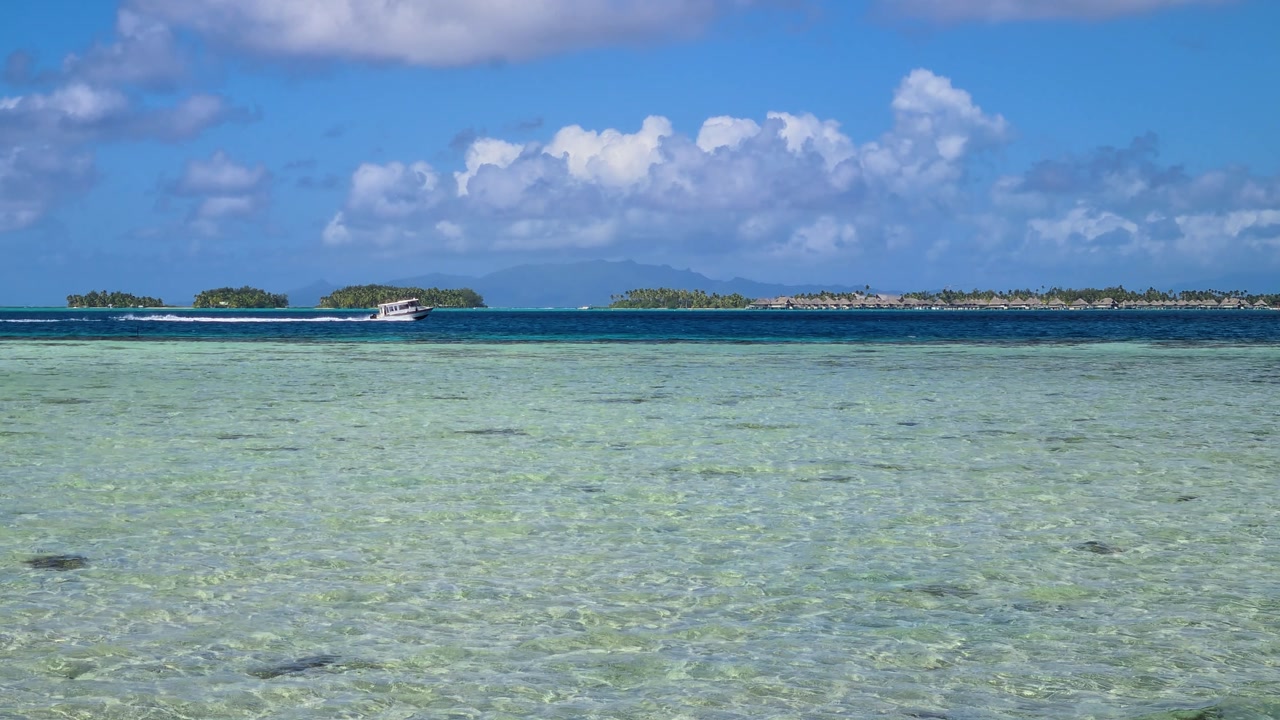 Bora Bora, French Polynesia, Timelapse of Boats in Lagoon and Clouds Above Tropical Resort