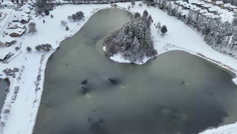 Aerial-view-of-a-large-pond-surrounded-by-suburban-neighborhoods