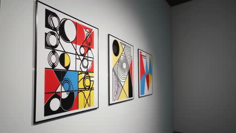 abstract geometric artworks displayed on a gallery wall