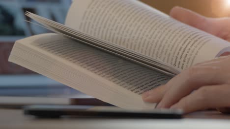 a close-up shot of a person flipping through the pages of a book