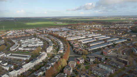 aerial dolly of a suburban area with rural farmlands in the background