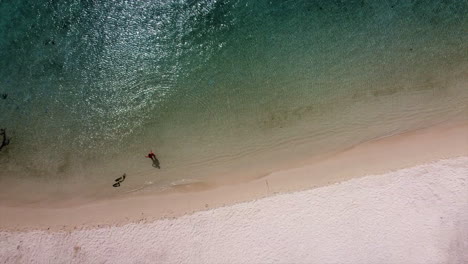 Ascending-aerial-shot-showing-person-standing-alone-in-beautiful-indian-ocean