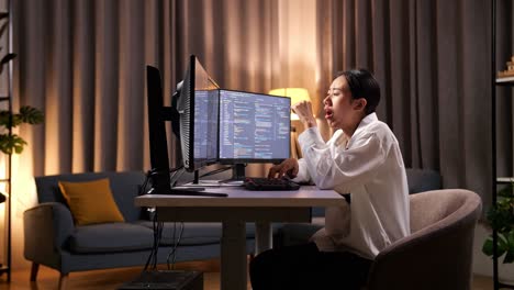 asian woman programmer yawning and sleeping while creating innovative software engineer developing app, program, video game on desktop computer at home. terminal with coding language