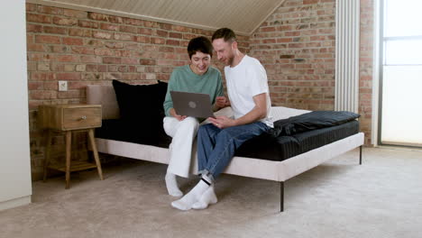 couple doing videocall on the bed