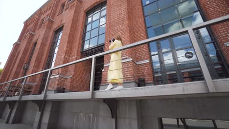 woman photographer in front of brick building