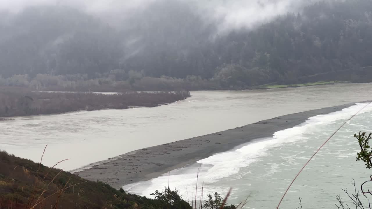 Handheld telephoto panning shot of the mouth of the Klamath River from the Klamath River Overlook in Northern California. 4K