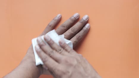 cleaning hands with a tissue