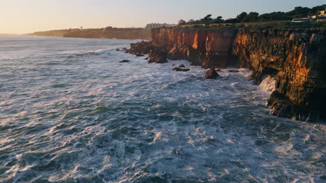 evening seascape rocky seacoast with foaming waving ocean water aerial view.