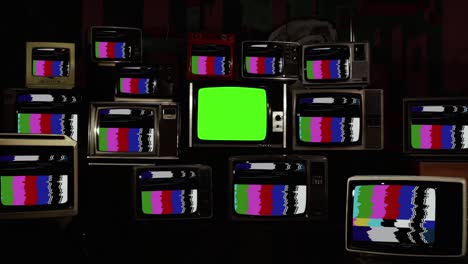 retro tvs with test pattern and noise and five old tvs turning on green screen.