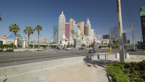 a jib up movement of the nyny resort in las vegas reveals an empty walkway and sparse traffic.