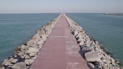 aerial shot from the breakwater in beach miramar and people walking