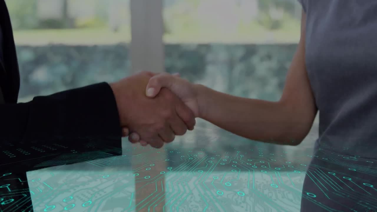 Microprocessor connections against mid section of businessman and businesswoman shaking hands