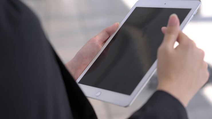 Business woman holding tablet computer. Concept of technology, business communication, shopping online and modern lifestyle.
