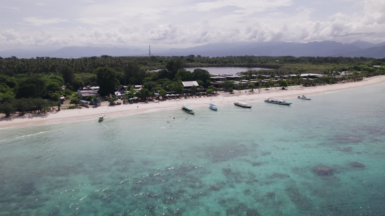 Aerial view circling the beach and boats in Gili Trawangan, in sunny Indonesia