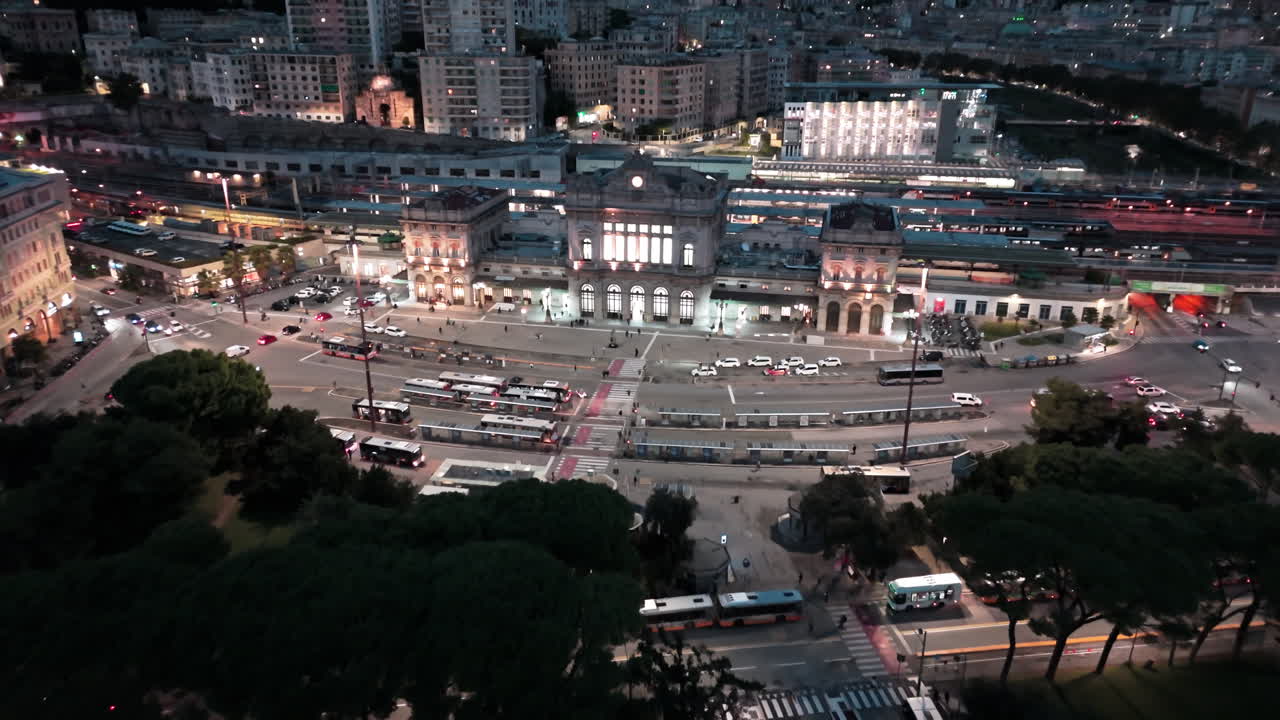 Iconic Brignole railway station in Genoa Italy lit up at night, aerial approach