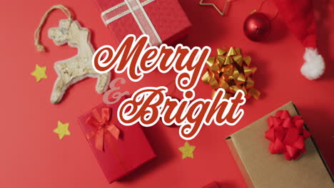 animation of merry and bright text, gift boxes, bauble, decoration materials on red background