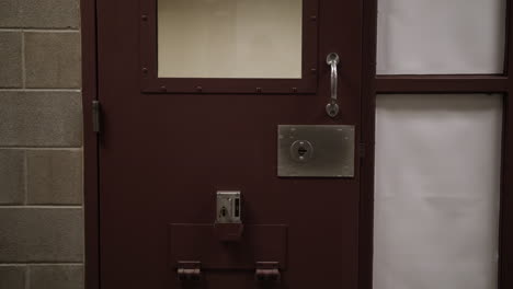 Prison-cell-door-inside-of-jail-or-prison-hallway