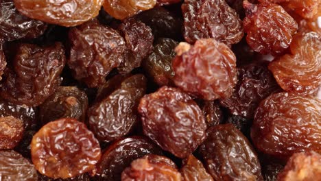 macro view of raisins cascading, highlighting texture and color variations under soft lighting