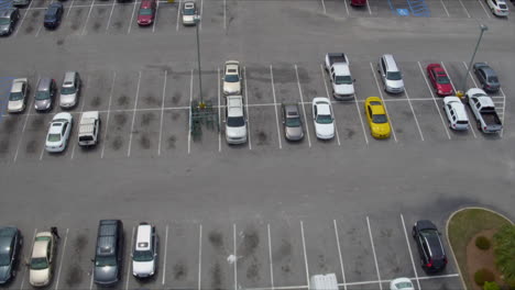 Aerial-Drone-Shot-Overlooking-Grocery-Store-Parking-Lot-on-Sunny-Day