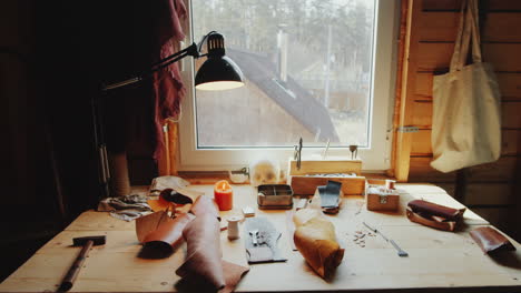 Desk-with-Craft-Tools-and-Leather-in-Workshop