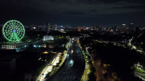 Aerial-reverse-shot-over-traffic-on-the-Periferico,-nighttime-in-Mexico-city