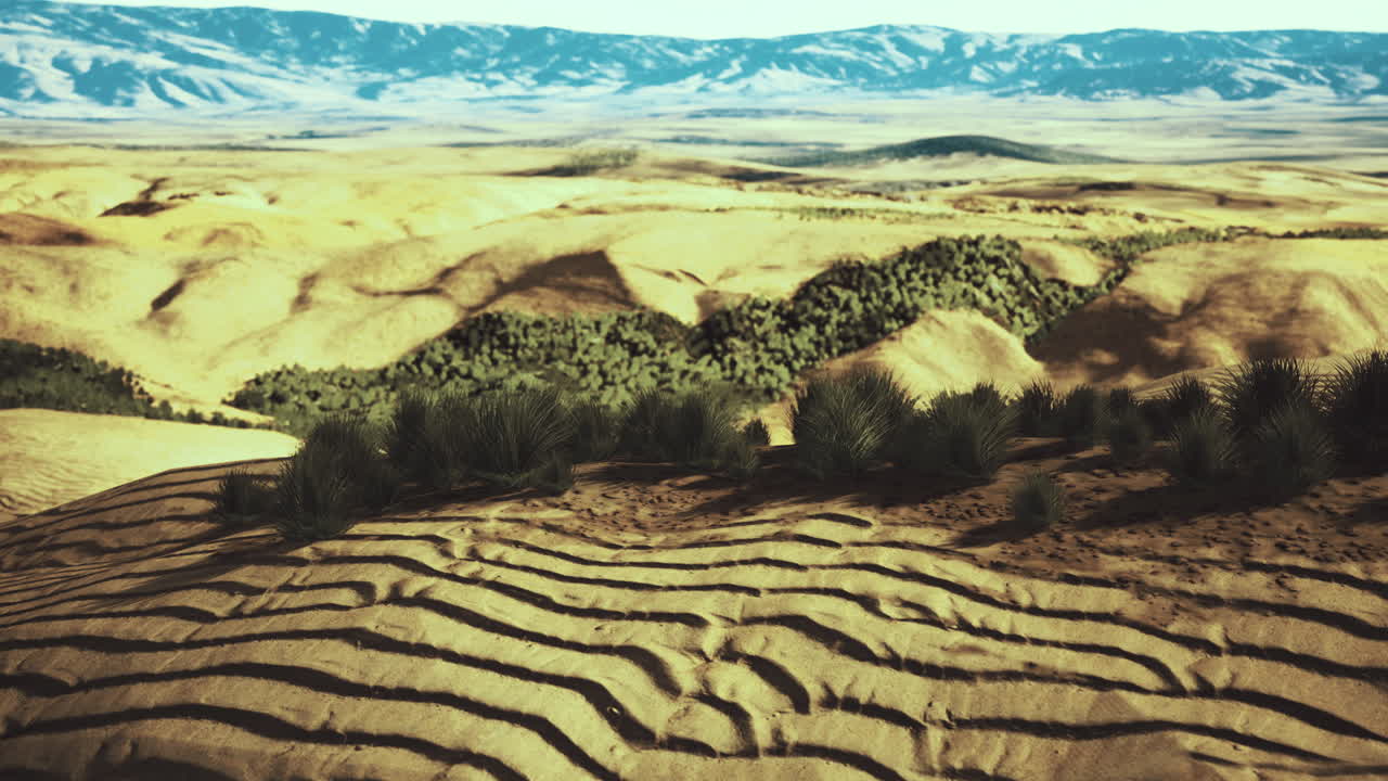 Vast desert landscape with undulating sand and distant mountains at sunset