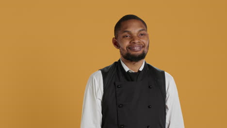 Skilled-waiter-showing-a-thumbs-up-symbol-in-front-of-the-camera