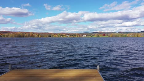 pov flight going off dock and up into sky autumn colors