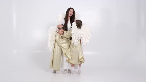 woman and children dressed as angels
