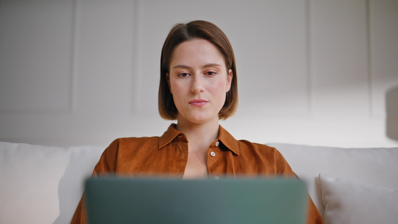Creative woman working computer sitting cozy apartment sofa closeup. Young lady