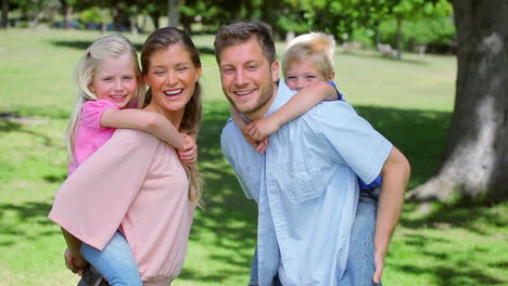 Boy-runs-and-jumps-onto-his-fathers-back-who-lifts-him-into-a-piggyback-him-a-piggy-back